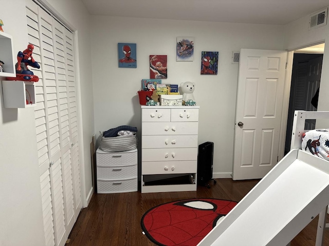 bedroom with dark hardwood / wood-style floors