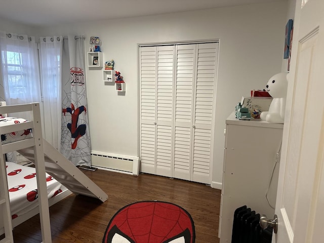 bedroom featuring dark hardwood / wood-style flooring and baseboard heating