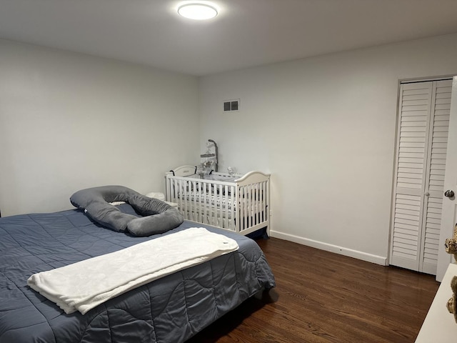 bedroom with dark wood-type flooring