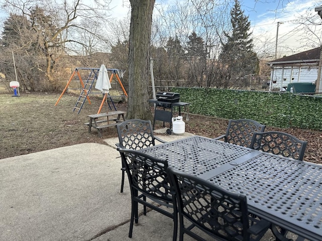 view of patio / terrace featuring a playground and grilling area