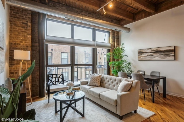 living room with wood ceiling, light wood-type flooring, and beamed ceiling