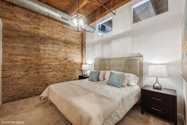 carpeted bedroom featuring beam ceiling and brick wall