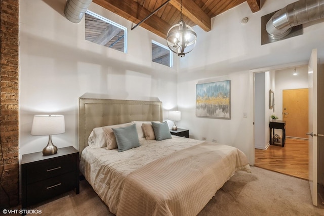 bedroom featuring beamed ceiling, a chandelier, a high ceiling, carpet, and wood ceiling