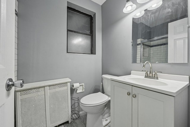 bathroom with vanity, a shower, and toilet