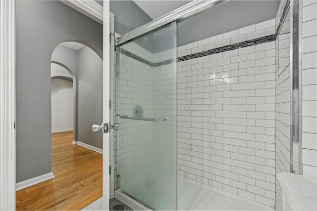 bathroom featuring hardwood / wood-style flooring and walk in shower