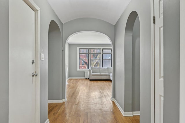 hallway with light hardwood / wood-style floors