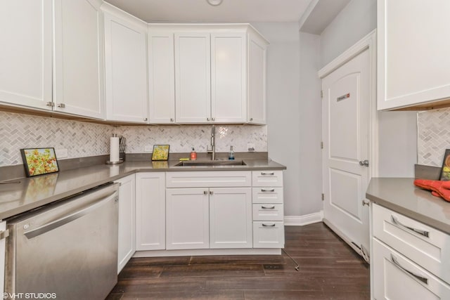 kitchen featuring tasteful backsplash, white cabinetry, dishwasher, sink, and dark wood-type flooring