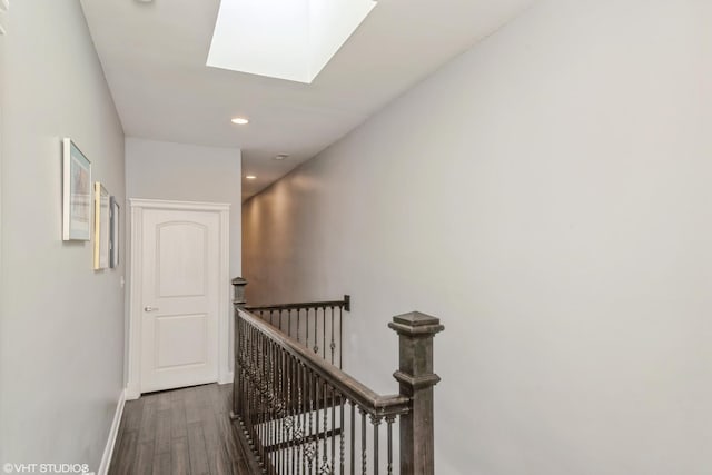 hall with dark hardwood / wood-style flooring and a skylight