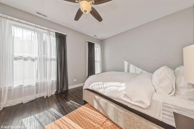 bedroom with dark hardwood / wood-style floors and ceiling fan