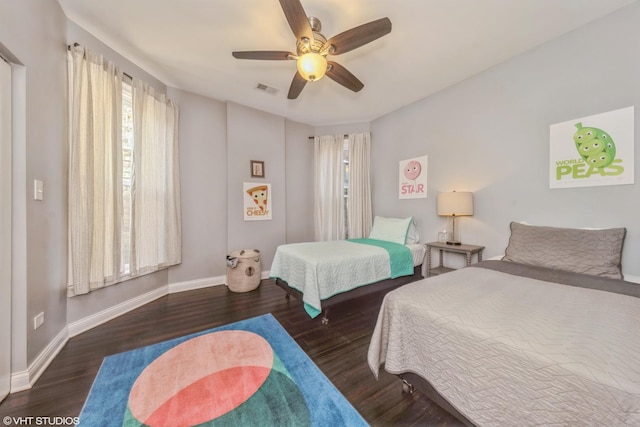 bedroom with ceiling fan and dark hardwood / wood-style flooring