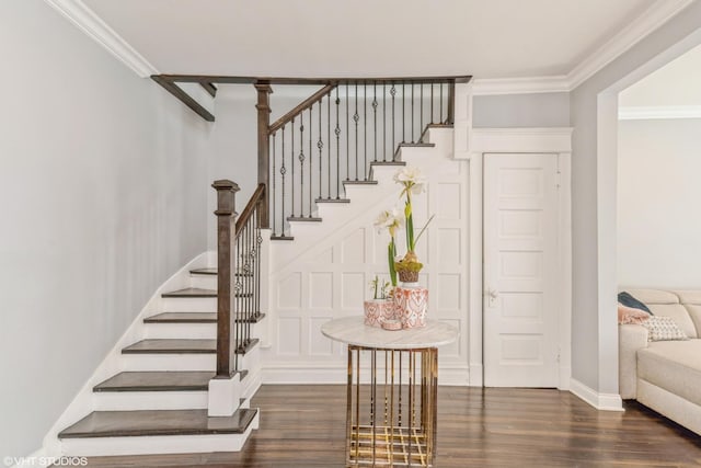 staircase with crown molding and hardwood / wood-style floors