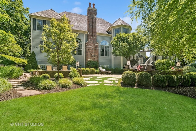 5605 Farmbrook Ln, Crystal Lake, IL 60014 - back of property with a lawn, a chimney, and a deck