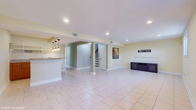 unfurnished living room with light tile patterned flooring