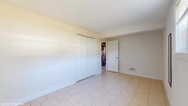 tiled spare room with plenty of natural light