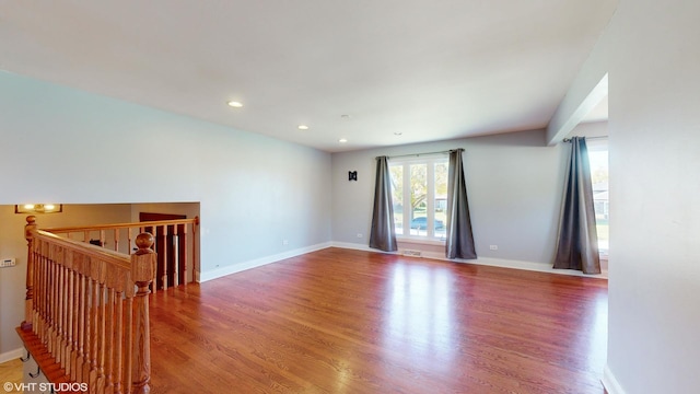 empty room with wood-type flooring and a healthy amount of sunlight