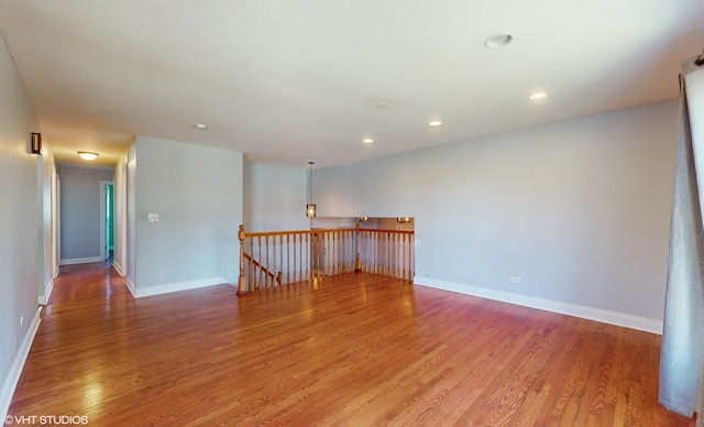 spare room with wood-type flooring