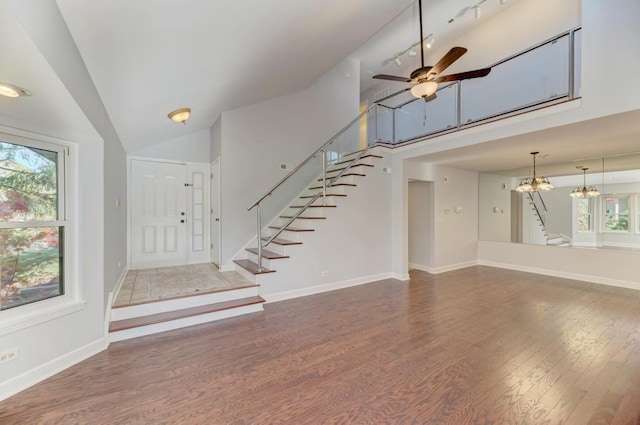 foyer featuring high vaulted ceiling, ceiling fan with notable chandelier, and dark hardwood / wood-style flooring