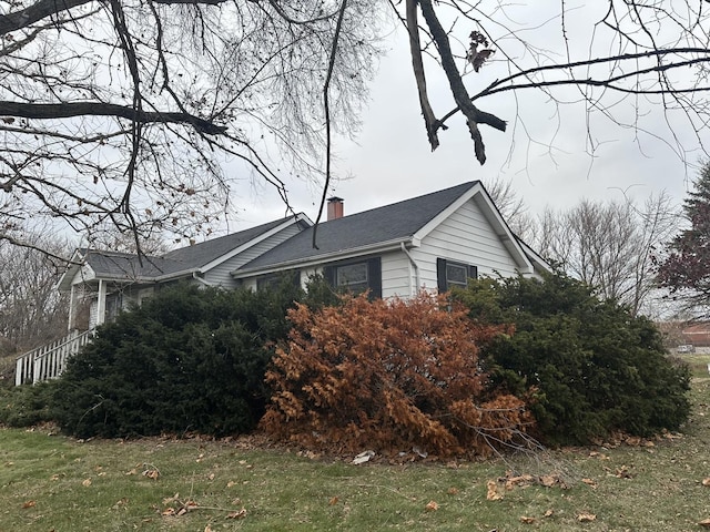 view of side of home featuring a lawn