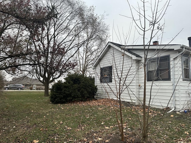 view of property exterior with a lawn