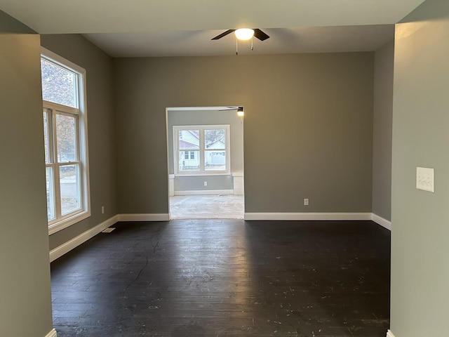 spare room with dark wood-type flooring and ceiling fan