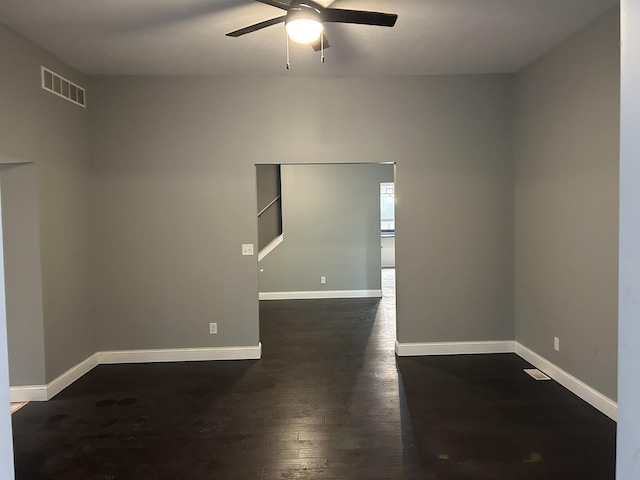 spare room featuring ceiling fan and dark hardwood / wood-style flooring