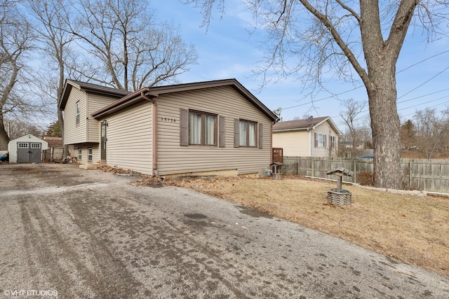 view of side of home with a storage shed