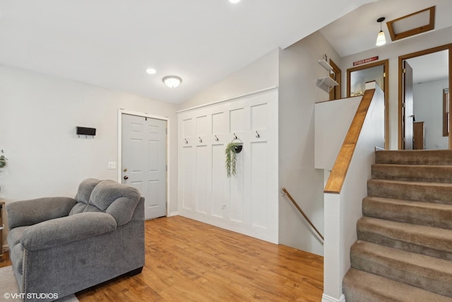 entryway with vaulted ceiling and light wood-type flooring