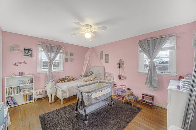 bedroom with light hardwood / wood-style floors and ceiling fan