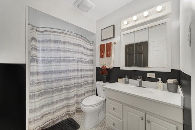 bathroom with vanity, toilet, and walk in shower