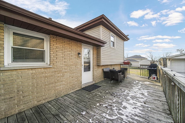 wooden terrace featuring grilling area