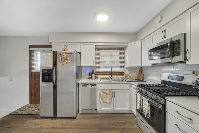 kitchen featuring white cabinetry, stainless steel appliances, and sink