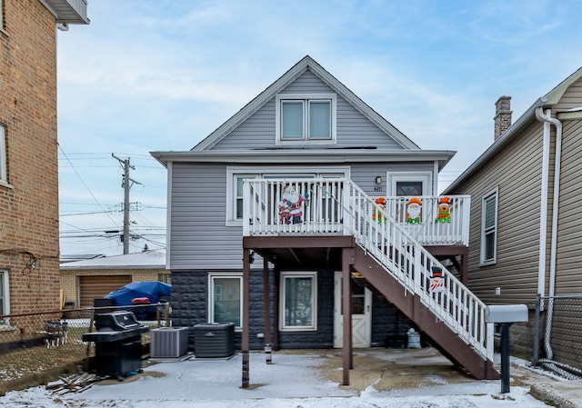 snow covered property with central AC unit