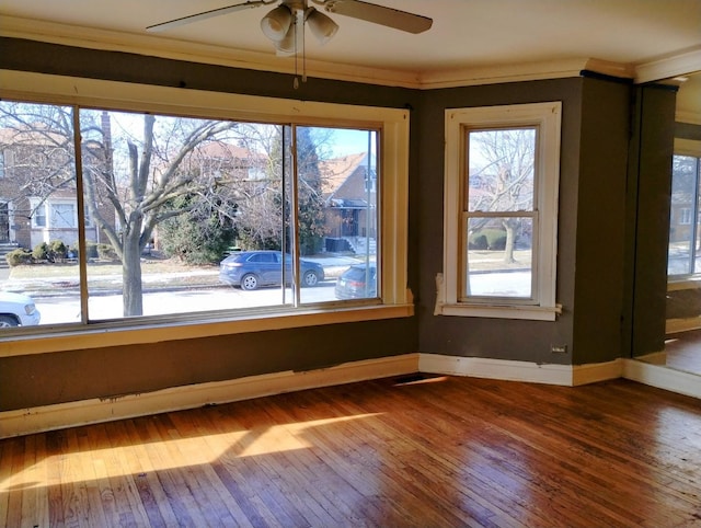 interior space featuring hardwood / wood-style flooring, ornamental molding, and ceiling fan