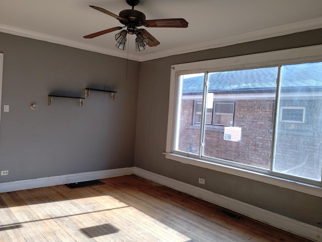 empty room with ceiling fan, ornamental molding, and light hardwood / wood-style floors