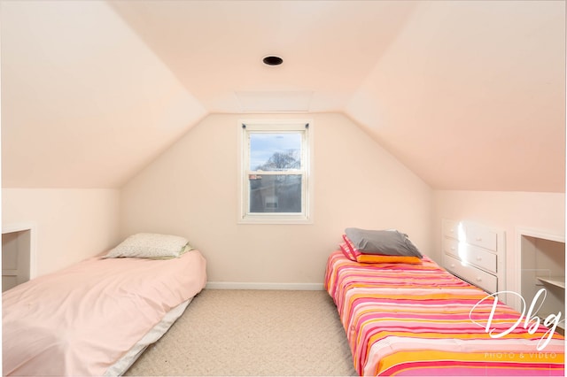 bedroom featuring light carpet and vaulted ceiling