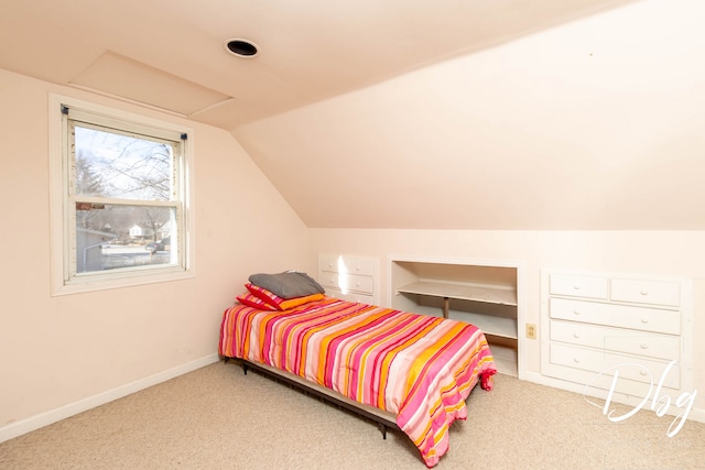 carpeted bedroom with lofted ceiling