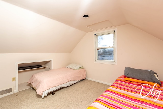 carpeted bedroom with lofted ceiling