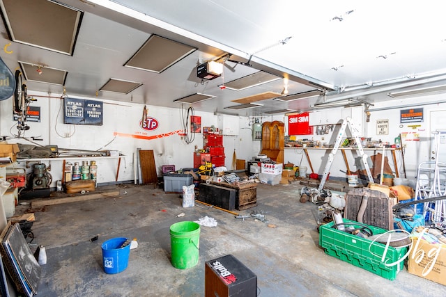 garage featuring a garage door opener and a workshop area