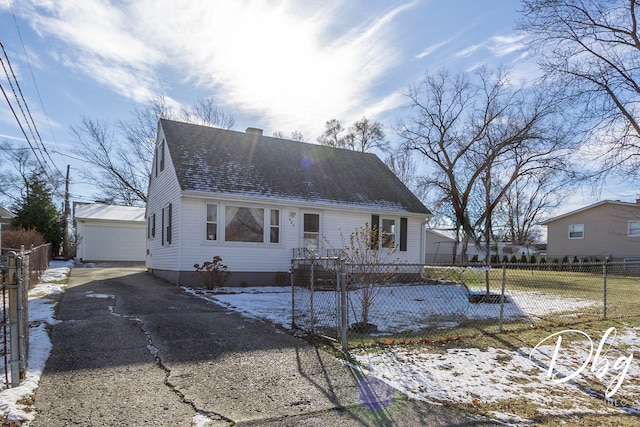 view of front of house with a garage and an outdoor structure