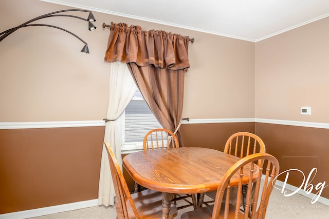 dining area featuring crown molding and carpet