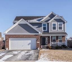 26011 S Old Farm Ct, Channahon, IL 60410 - view of front of house with a porch, asphalt driveway, brick siding, and a garage