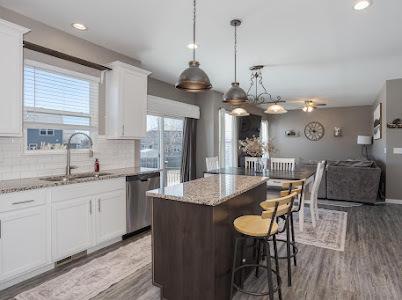 26011 S Old Farm Ct, Channahon, IL 60410 - kitchen featuring stainless steel dishwasher, a sink, a kitchen island, light stone counters, and ceiling fan