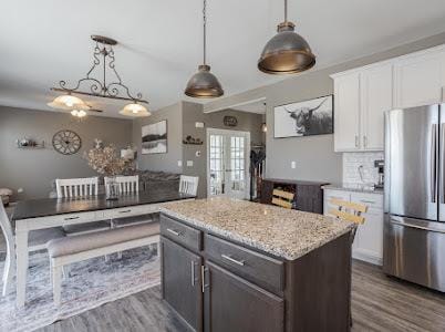 26011 S Old Farm Ct, Channahon, IL 60410 - kitchen with freestanding refrigerator, dark wood-style floors, white cabinets, and decorative light fixtures