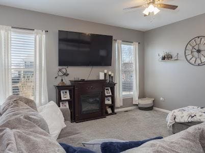26011 S Old Farm Ct, Channahon, IL 60410 - carpeted living room featuring a ceiling fan, baseboards, and a glass covered fireplace