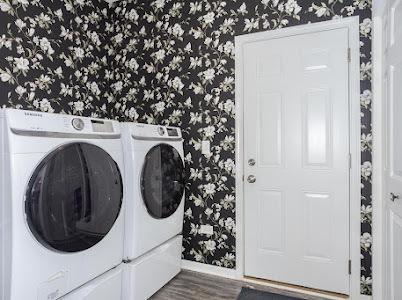 26011 S Old Farm Ct, Channahon, IL 60410 - laundry room with wallpapered walls, washer and clothes dryer, baseboards, and wood finished floors
