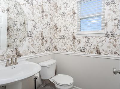 26011 S Old Farm Ct, Channahon, IL 60410 - half bath featuring wallpapered walls, wainscoting, toilet, plenty of natural light, and a sink