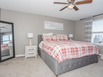 26011 S Old Farm Ct, Channahon, IL 60410 - carpeted bedroom featuring multiple windows, baseboards, and ceiling fan