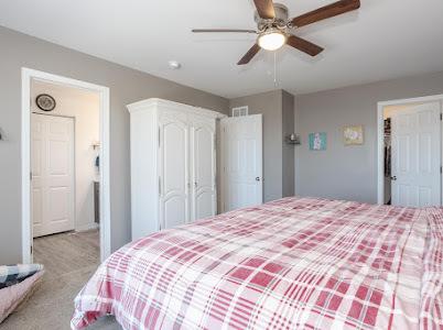 26011 S Old Farm Ct, Channahon, IL 60410 - carpeted bedroom featuring a ceiling fan