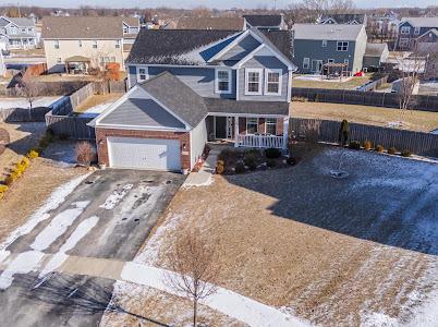 26011 S Old Farm Ct, Channahon, IL 60410 - traditional-style home with asphalt driveway, a garage, fence, covered porch, and a residential view