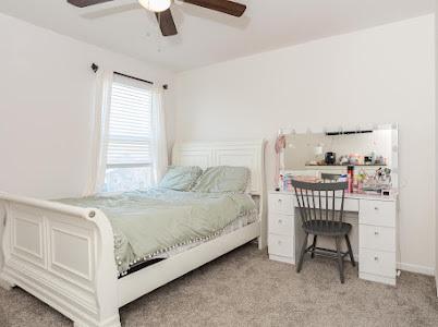 26011 S Old Farm Ct, Channahon, IL 60410 - bedroom with light carpet, a desk, and a ceiling fan